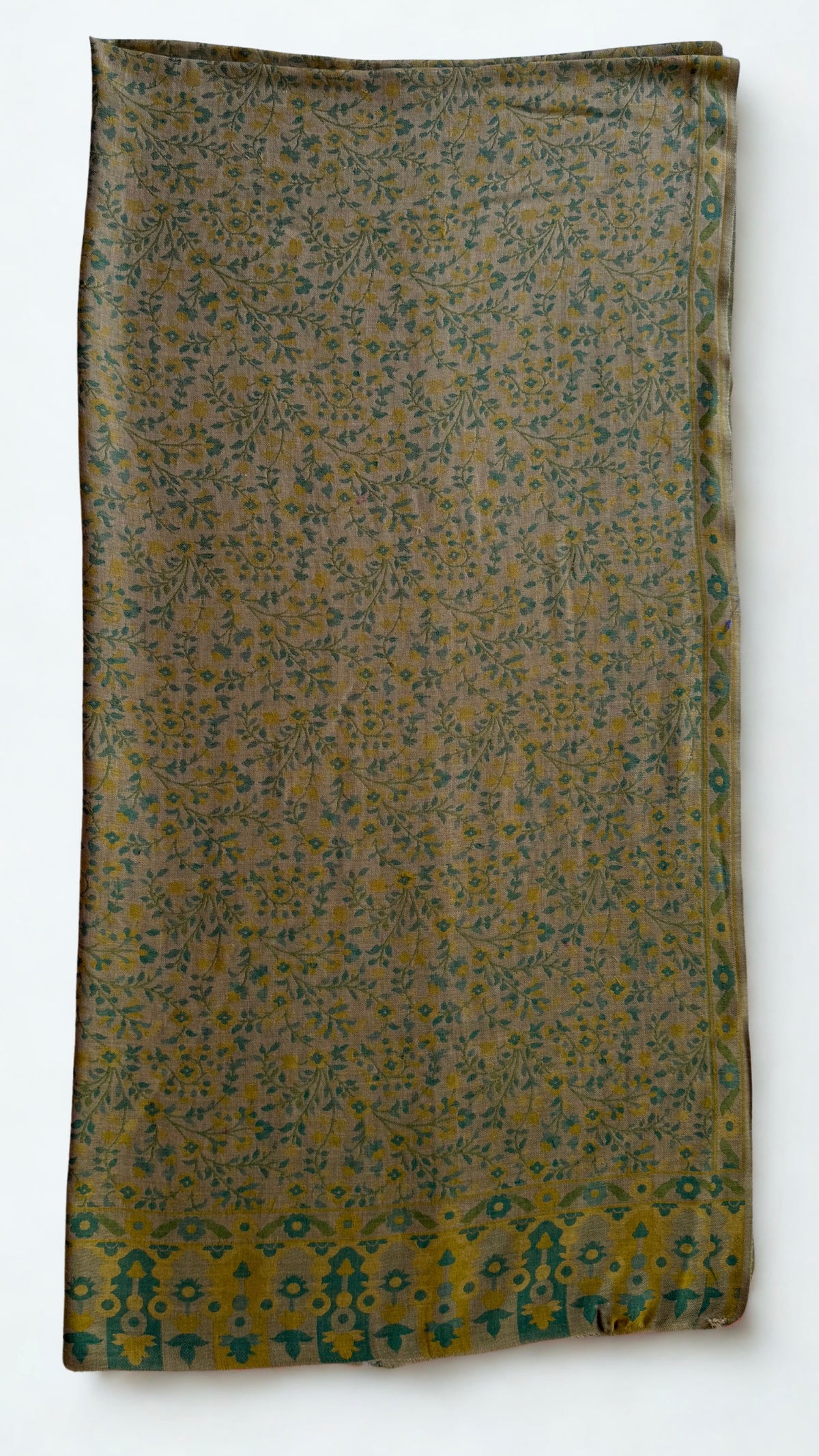 Moss and ochre Kani pashmina shawl folded lengthwise, showing the scrolling side border and the bold end panel