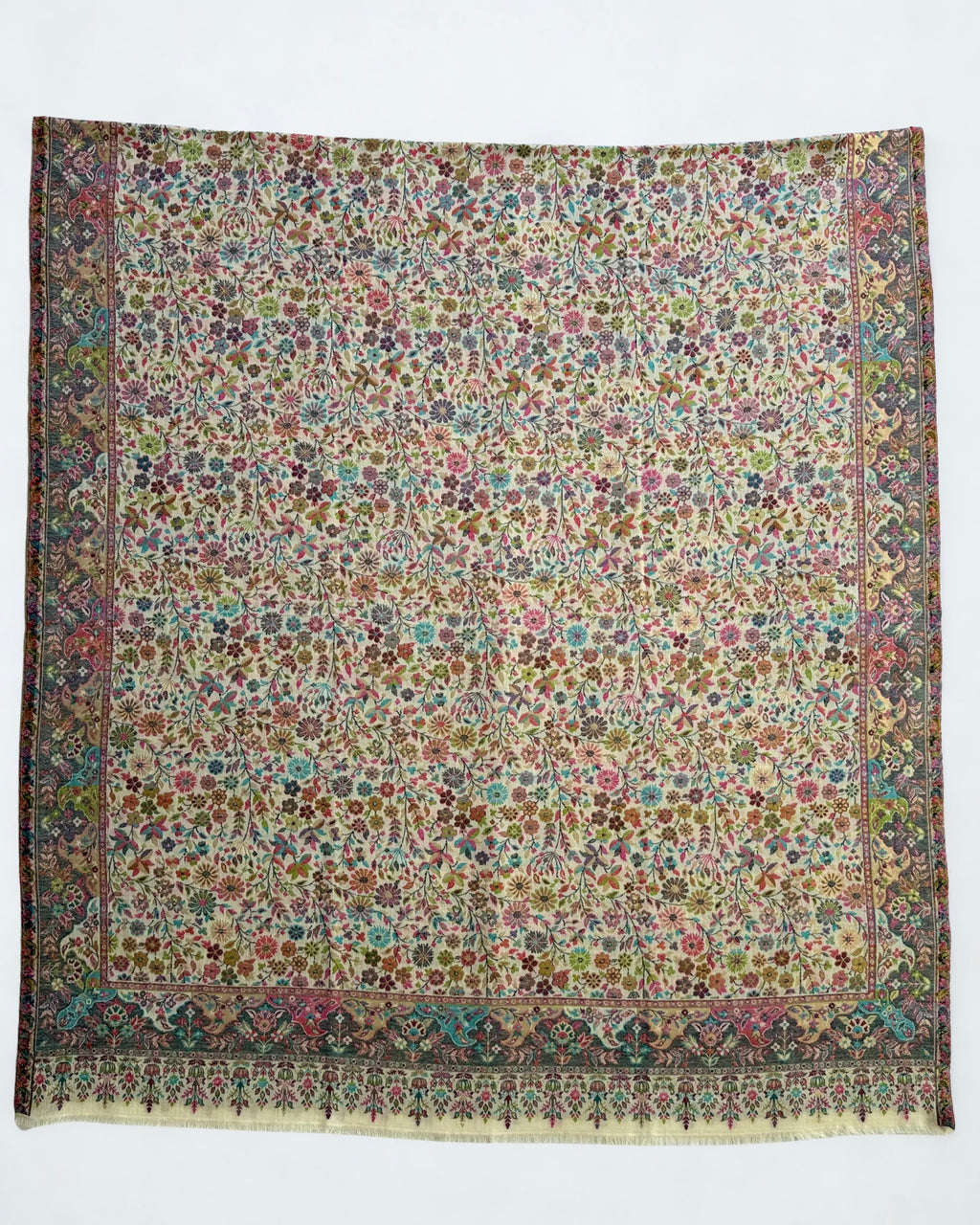 Ivory Zari Kani pashmina shawl gathered in a soft swirl, showing the drape and the gold zari lifting through the pale floral weave