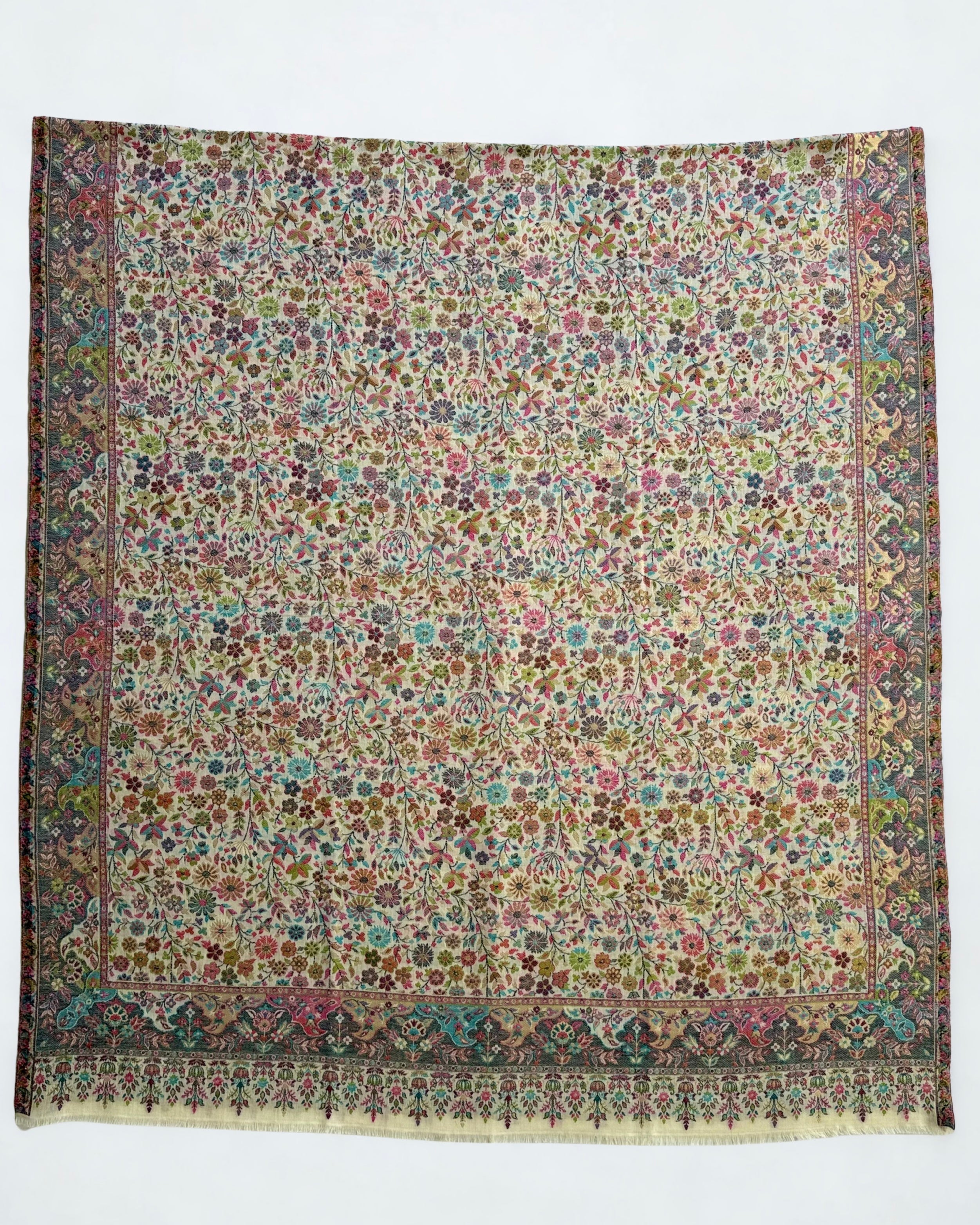 Ivory Zari Kani pashmina shawl gathered in a soft swirl, showing the drape and the gold zari lifting through the pale floral weave