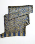 Ivory Kani pashmina shawl laid flat, handwoven cobalt and olive floral field with an arched end border