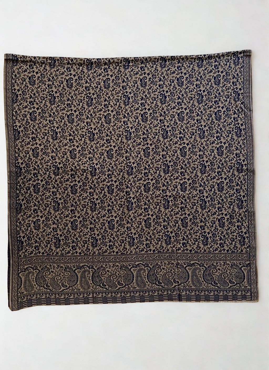 Stone and navy Kani pashmina shawl folded to show the woven paisley border and striped end panel