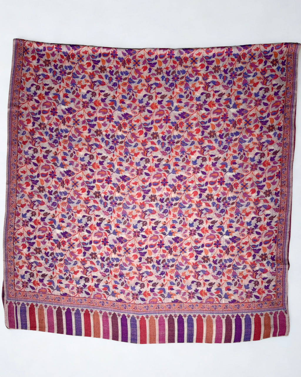 Blush Kani pashmina shawl folded back to show the reverse of the handwoven multicolour pattern
