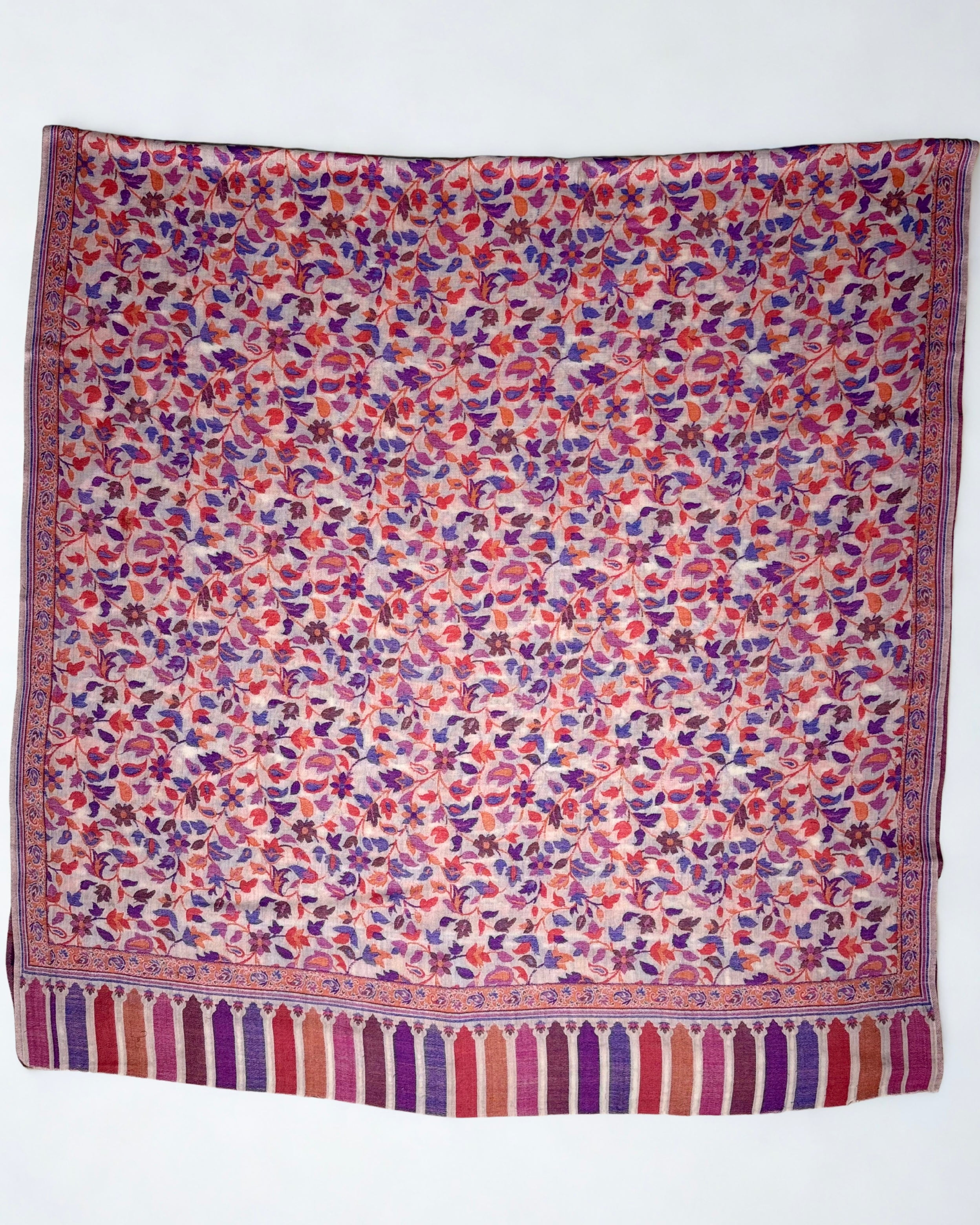 Blush Kani pashmina shawl folded back to show the reverse of the handwoven multicolour pattern