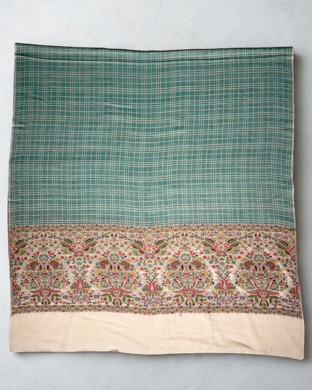 Sea green check Kani pashmina shawl folded to show both ivory floral end borders and the plain cream panels