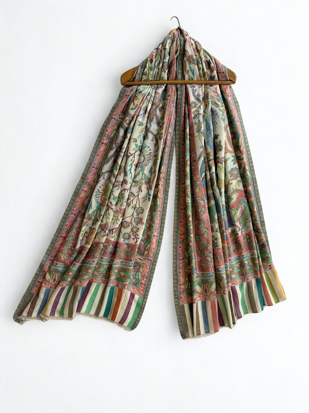 Ivory Kani shikargah pashmina shawl folded to show the hunting-scene field, concentric woven borders and multicoloured striped end band