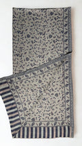 Stone grey Indian pashmina shawl folded lengthwise, indigo paisley field with a woven leaf border and striped end panel