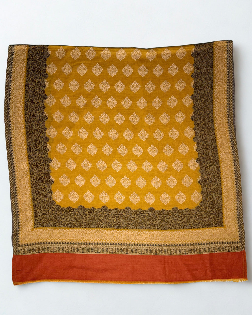 Mustard Kani border pashmina shawl folded in soft layers, showing the buta field, paisley border and rust end