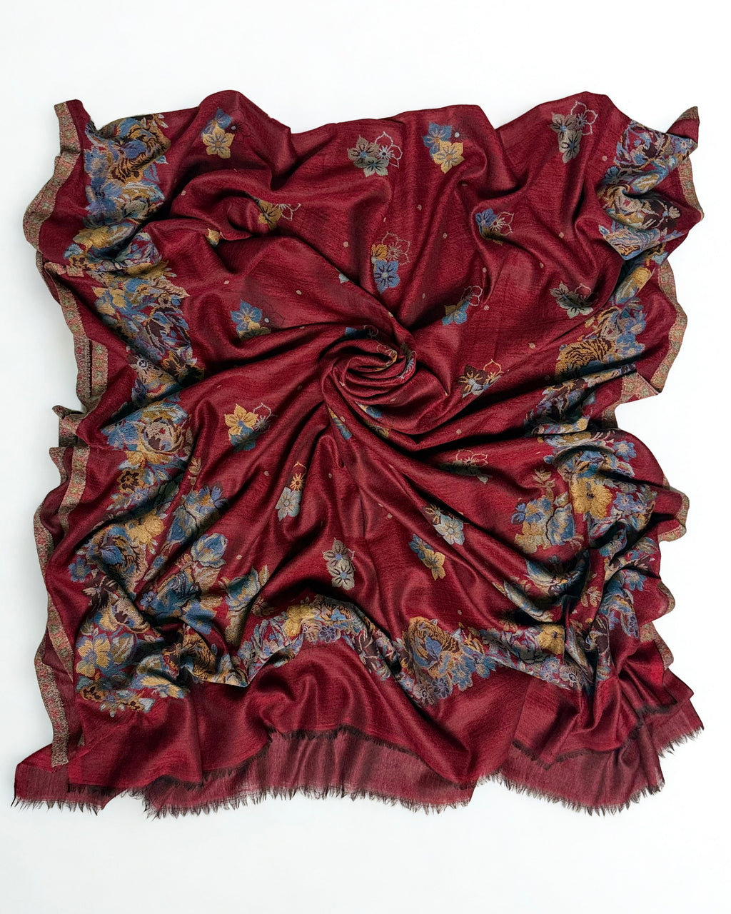 Claret Kani pashmina shawl laid flat, scattered floral field framed by a wide border of blue and gold roses