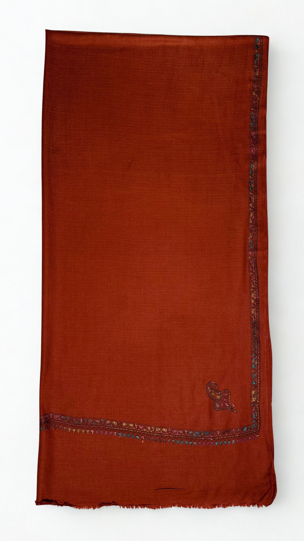 Rust Swati Shahtoosh shawl in soft folds, showing the drape and the fine embroidered edge