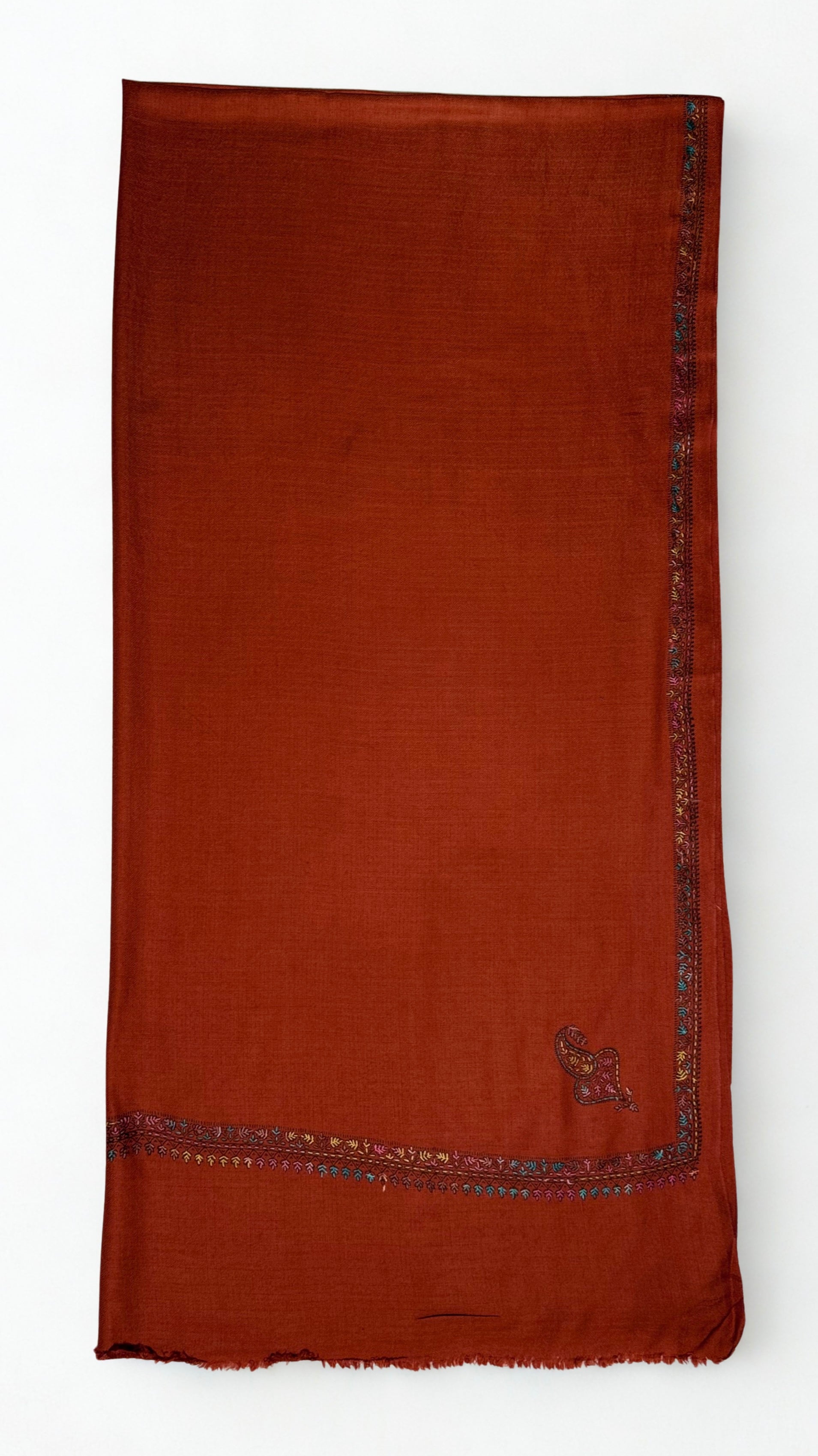 Rust Swati Shahtoosh shawl in soft folds, showing the drape and the fine embroidered edge