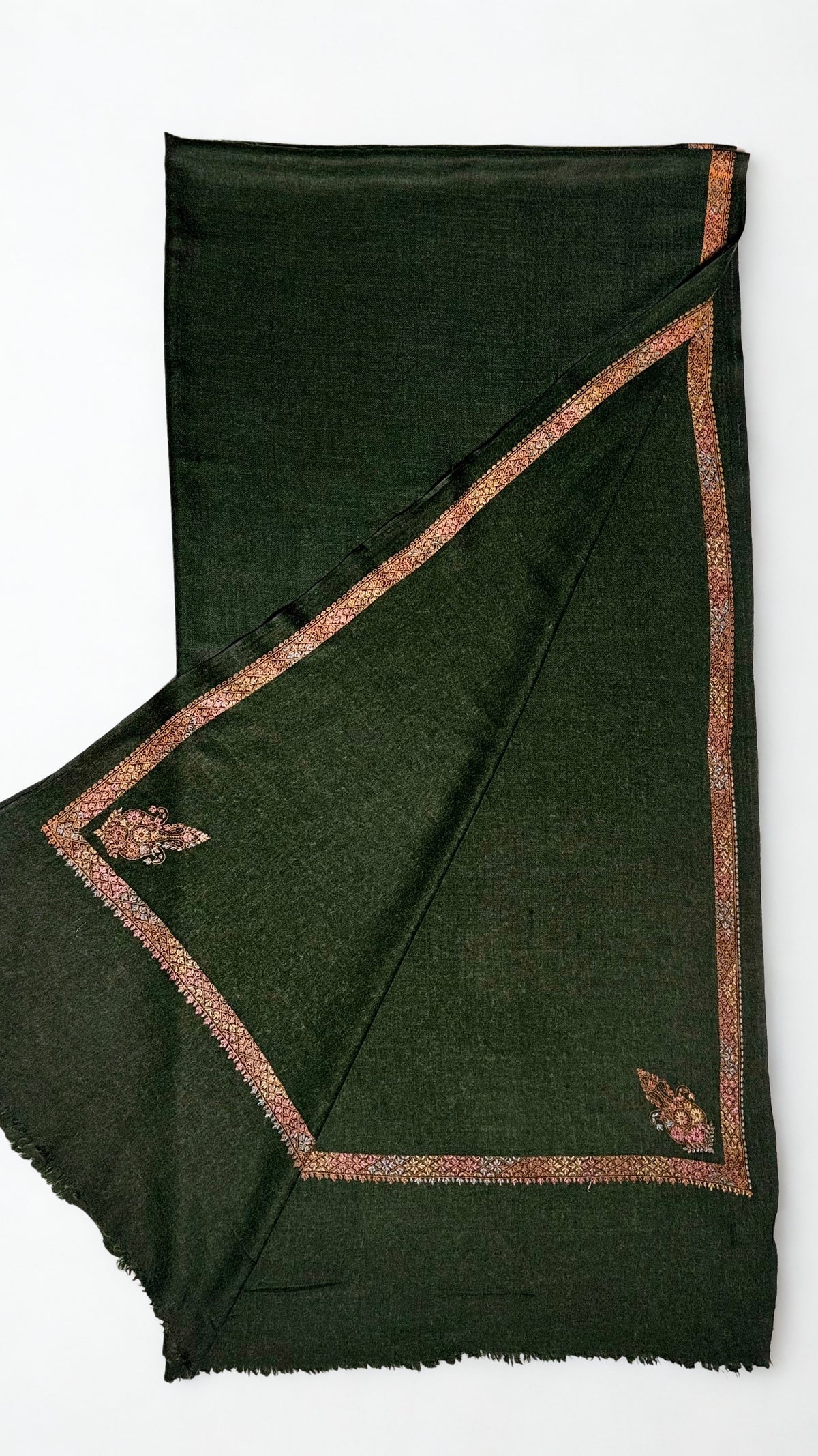 Forest green Swati Shahtoosh shawl folded back to show both corner buta and the embroidered border meeting at the corner