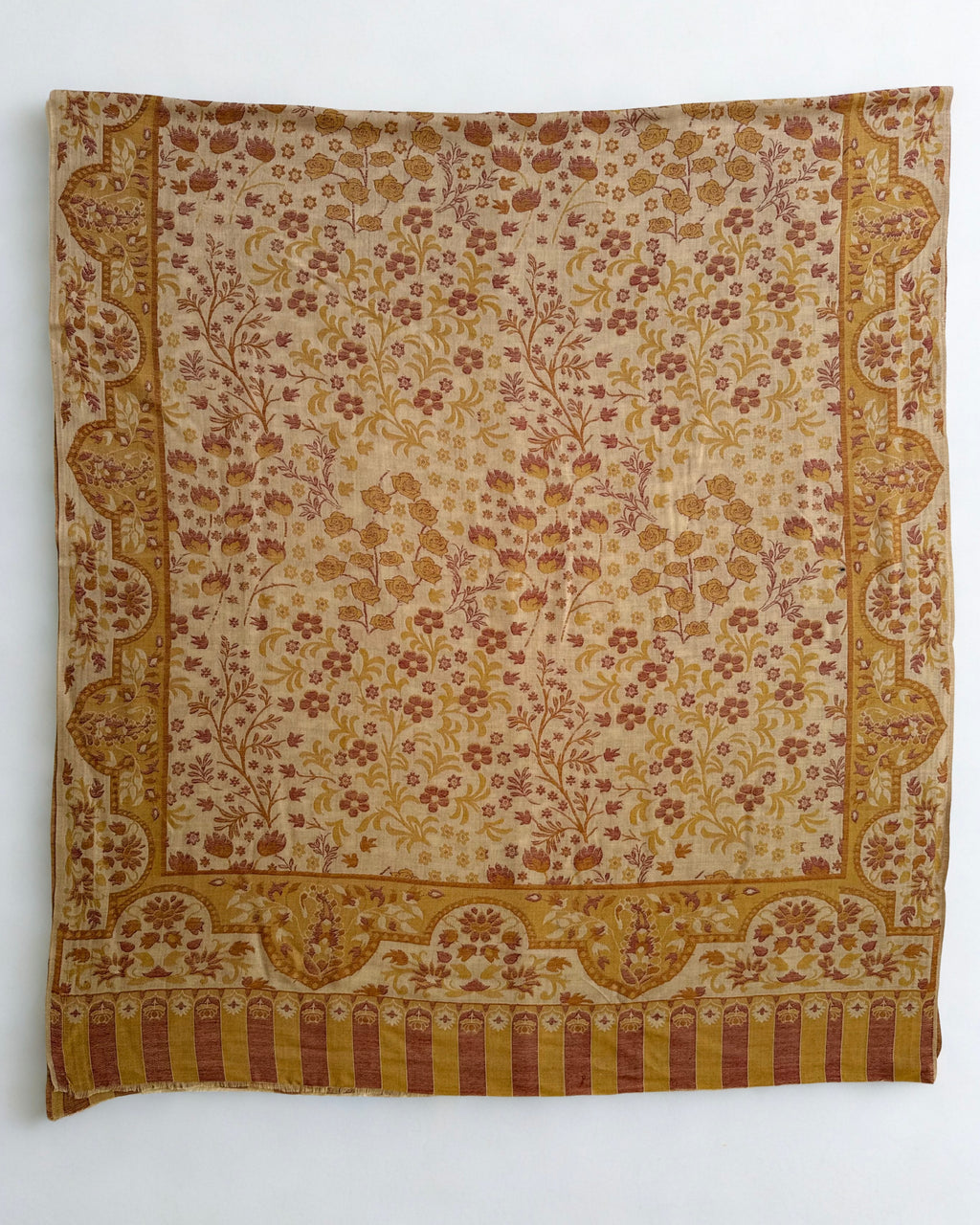 Sand and rose Kani pashmina shawl folded to show the scalloped paisley border meeting the striped colonnade end