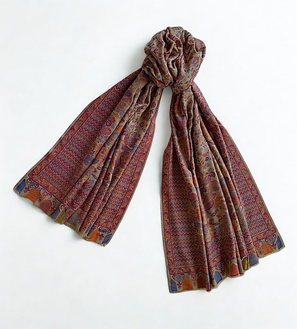 Close view of the zigzag border and coloured arched niches on an antique rose Kani pashmina shawl