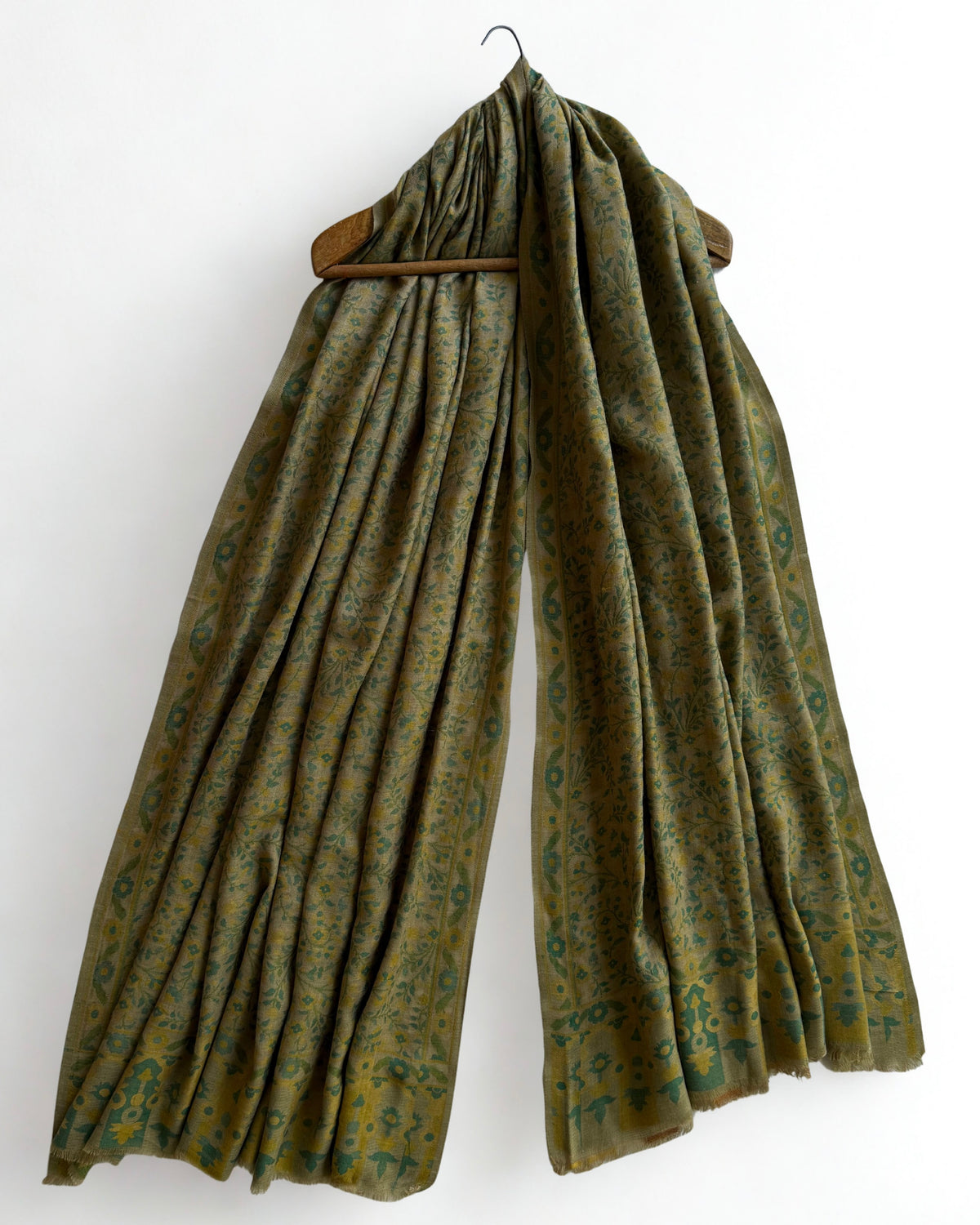 Moss and ochre Kani pashmina shawl folded back to show the reverse of the fine vine weave and the teal and gold end blocks