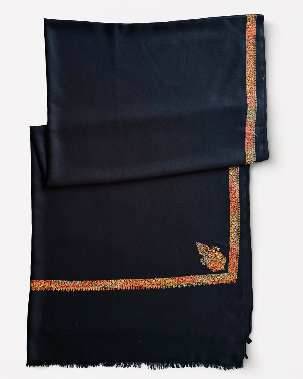 Black Swati Shahtoosh folded, showing the border running along all four sides and the fringed edge