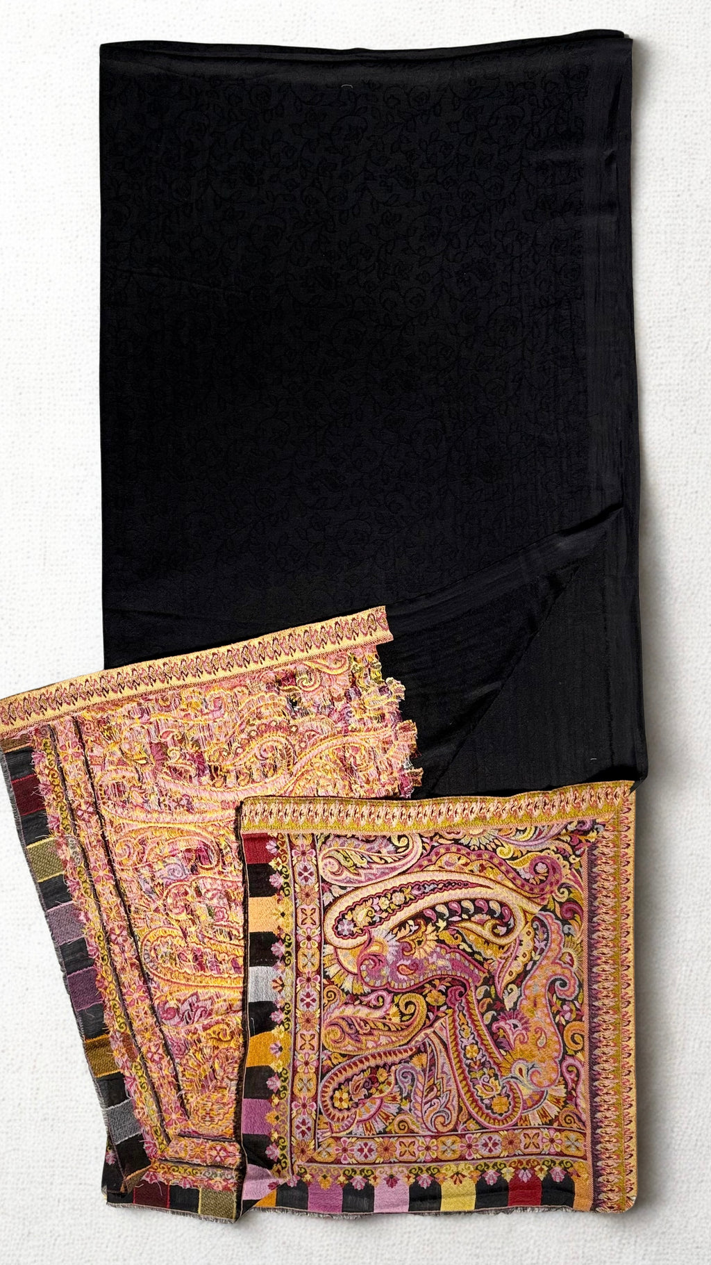 Black ek rukh pashmina ring shawl gathered in soft folds, self-woven paisley ground meeting a broad rose and gold paisley end panel