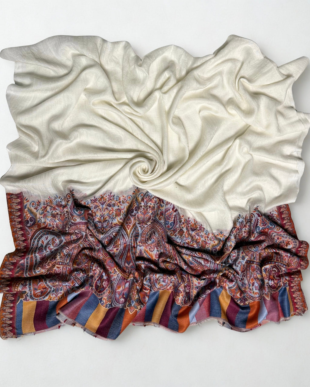 Detail of the paisley motifs and striped border of the white and terracotta Palladar shawl