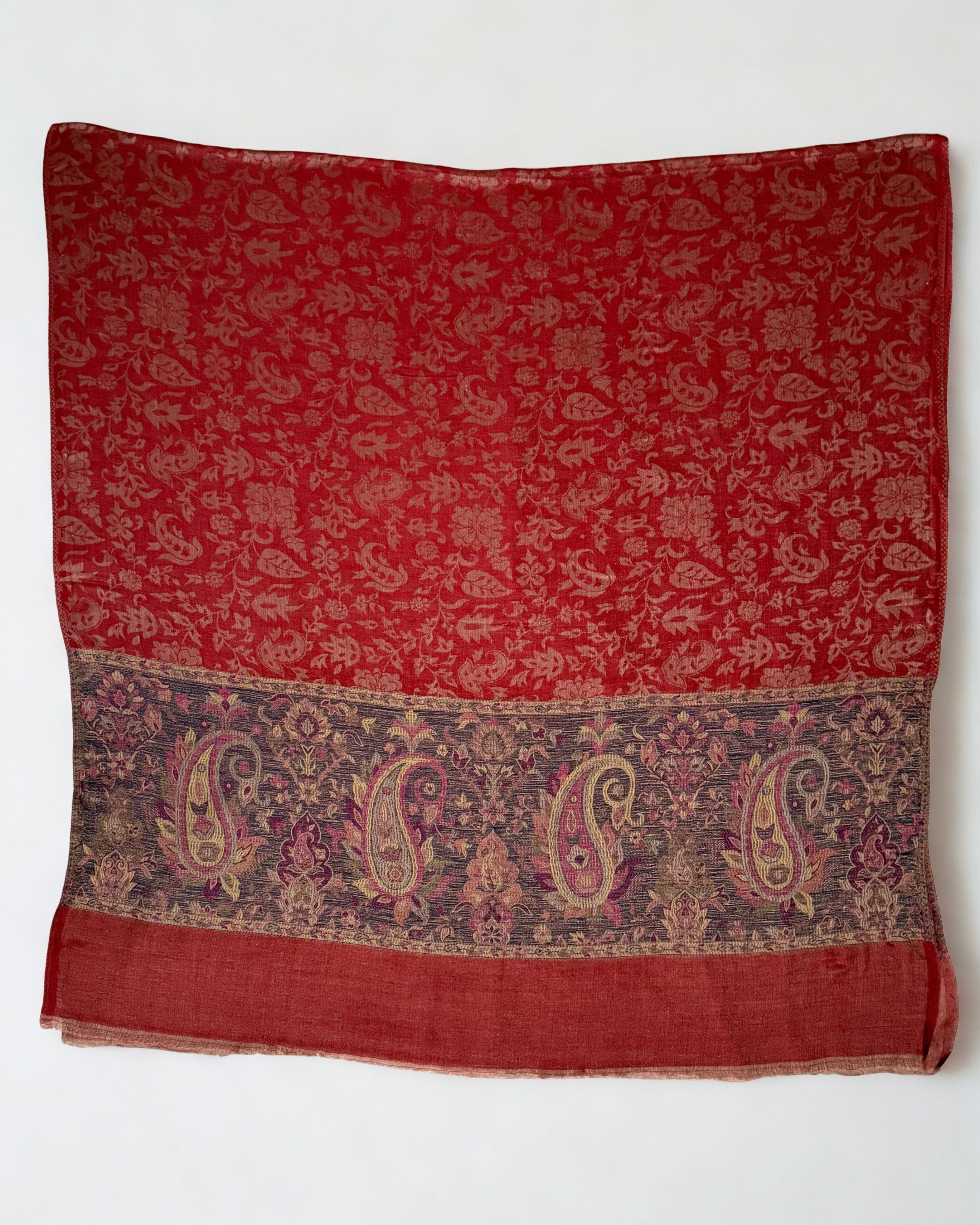 Detail of the indigo paisley border against the scarlet ground