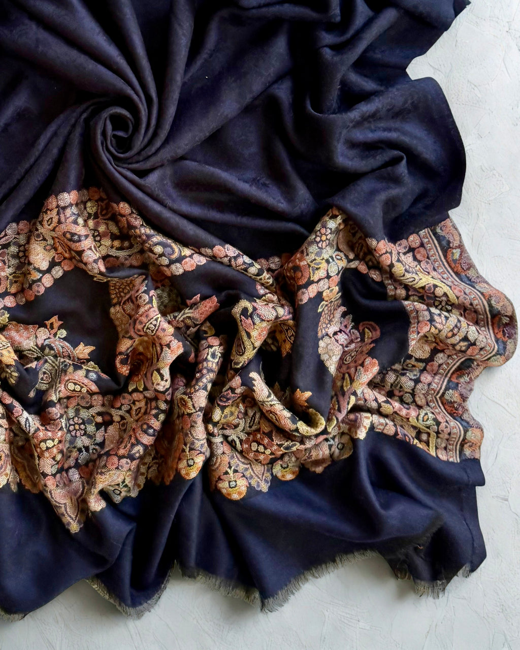 Self-patterned damask medallion woven into the navy ground in the same colour