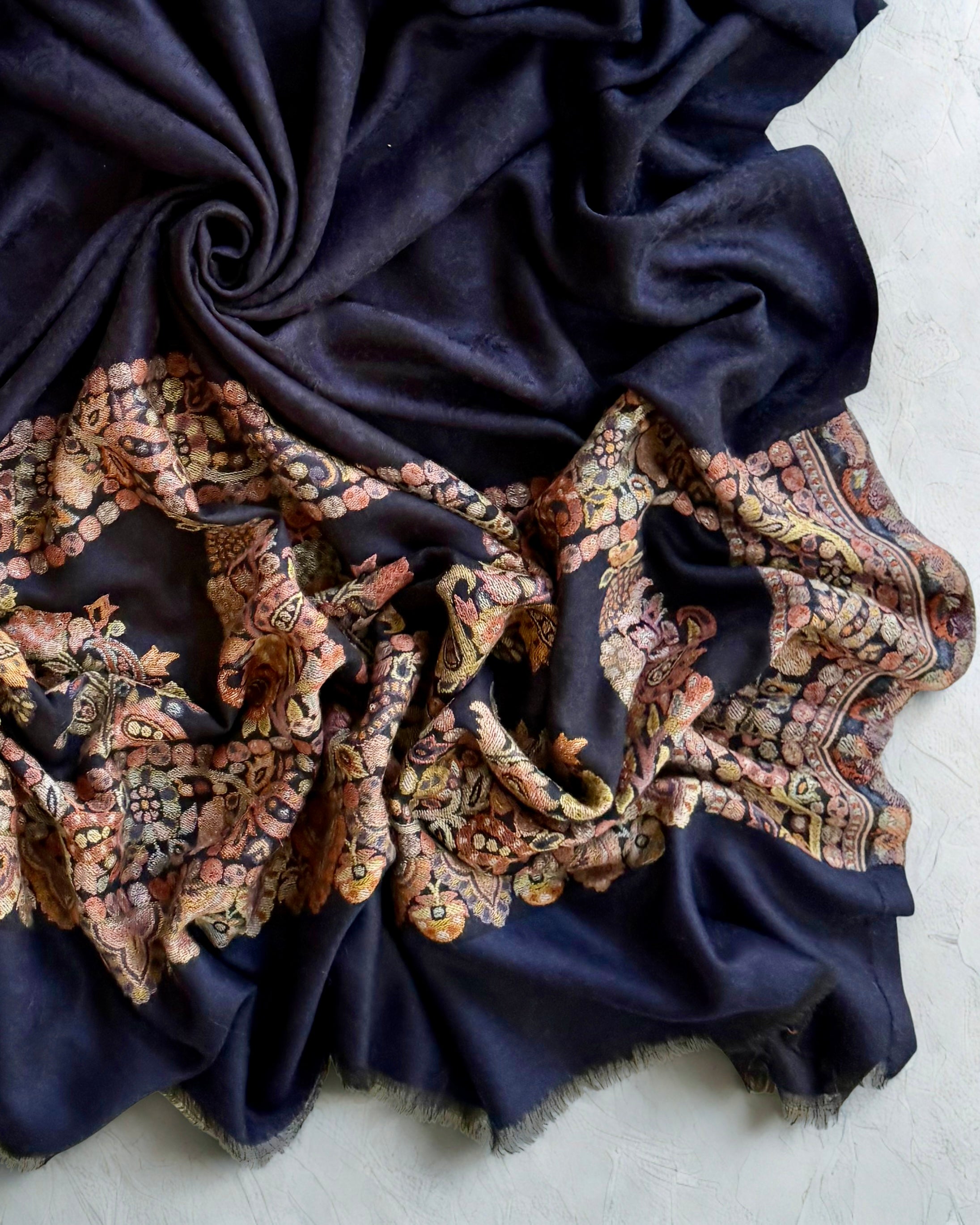 Self-patterned damask medallion woven into the navy ground in the same colour