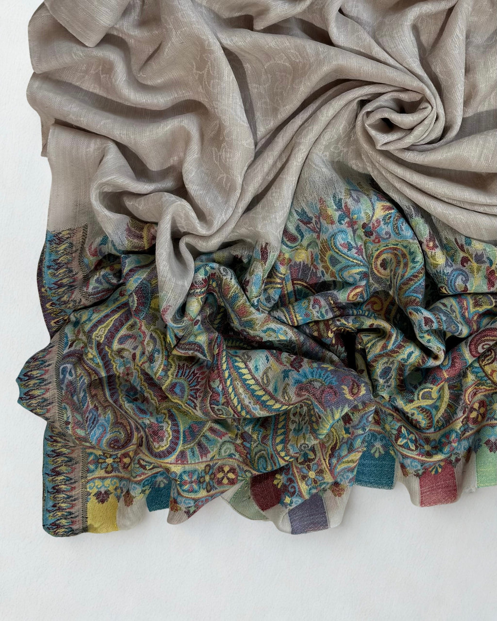 Full view of the stone grey pashmina shawl with its turquoise paisley end panel