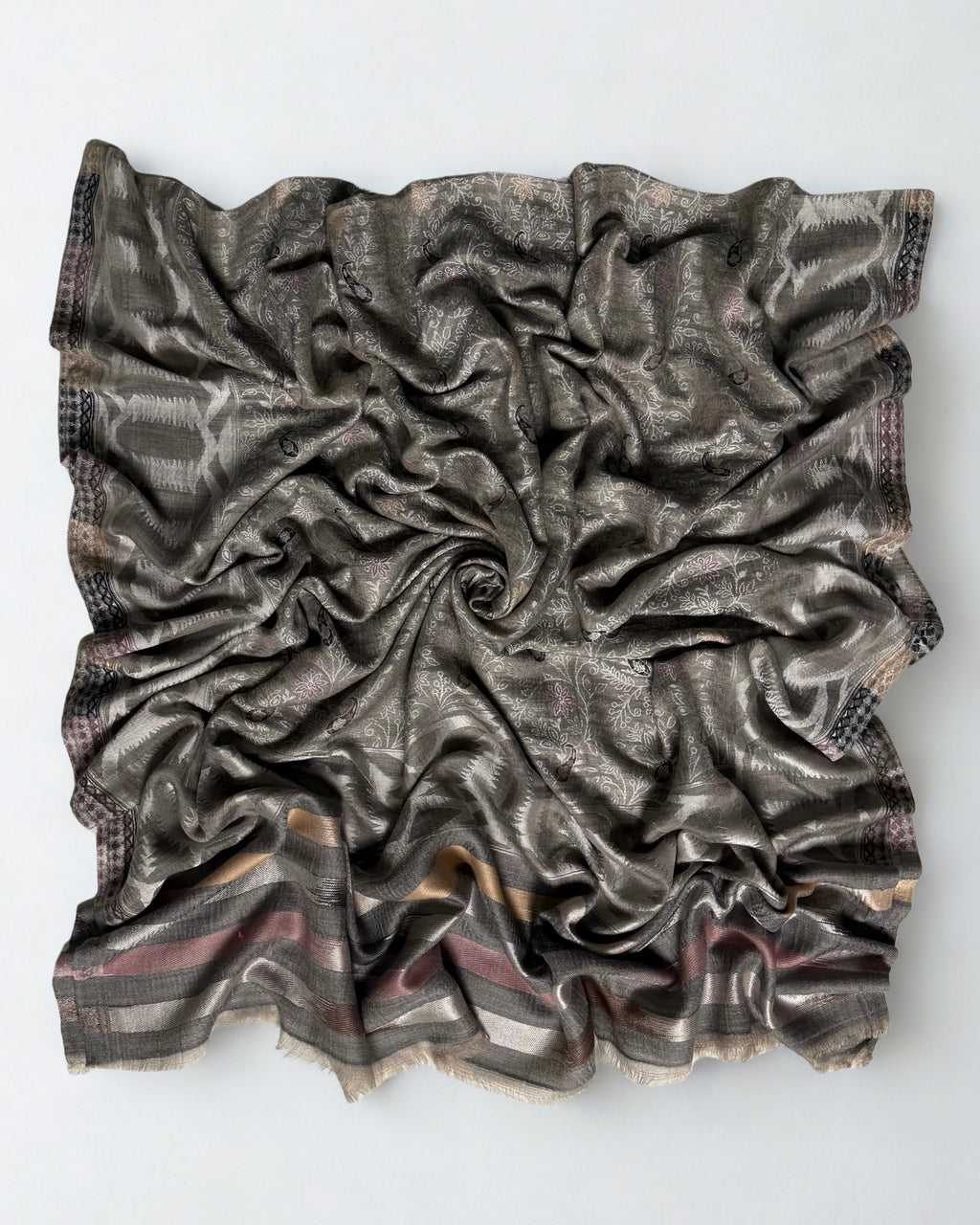 Both ends of the silver grey jamawar shawl side by side, borders matched