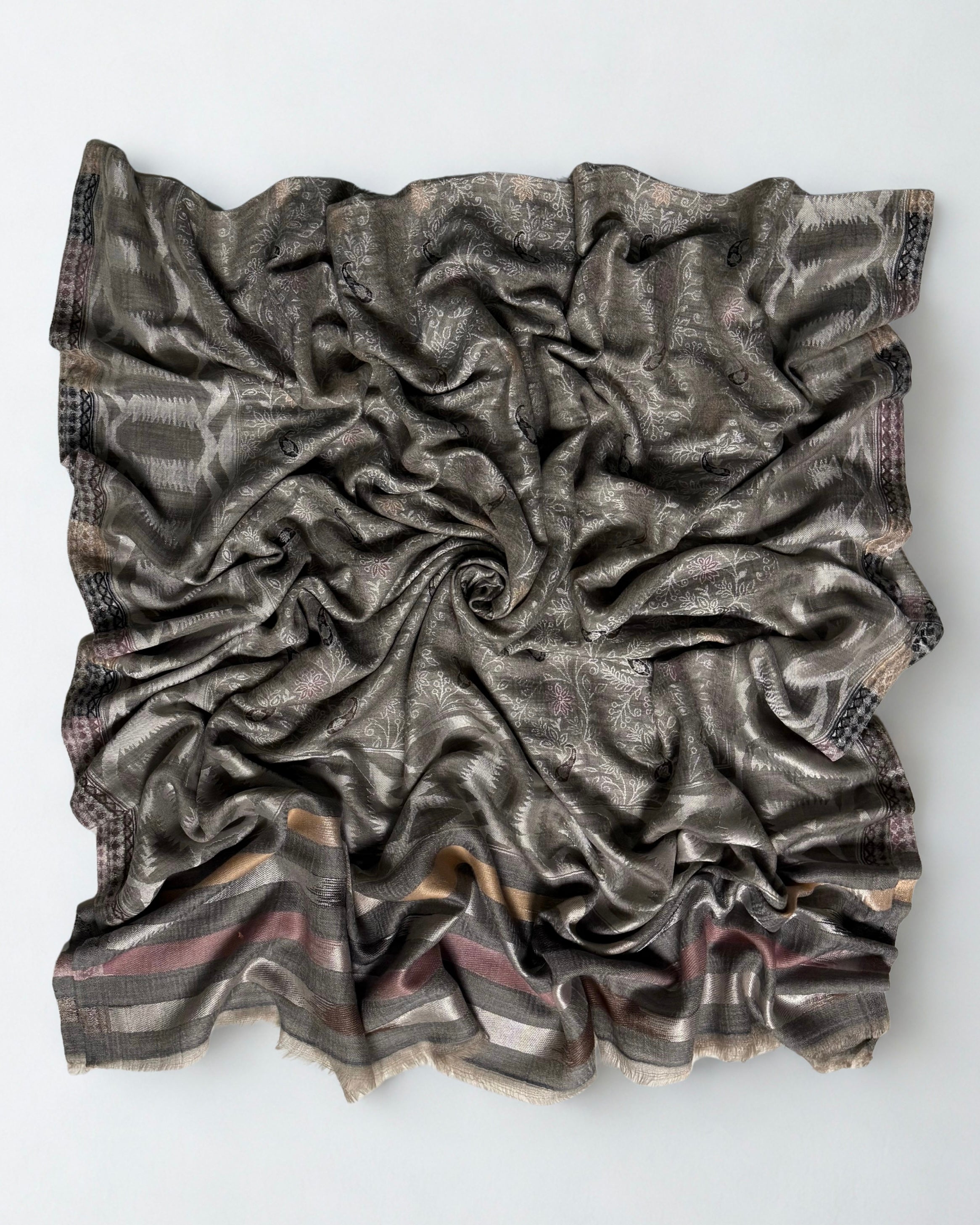 Both ends of the silver grey jamawar shawl side by side, borders matched