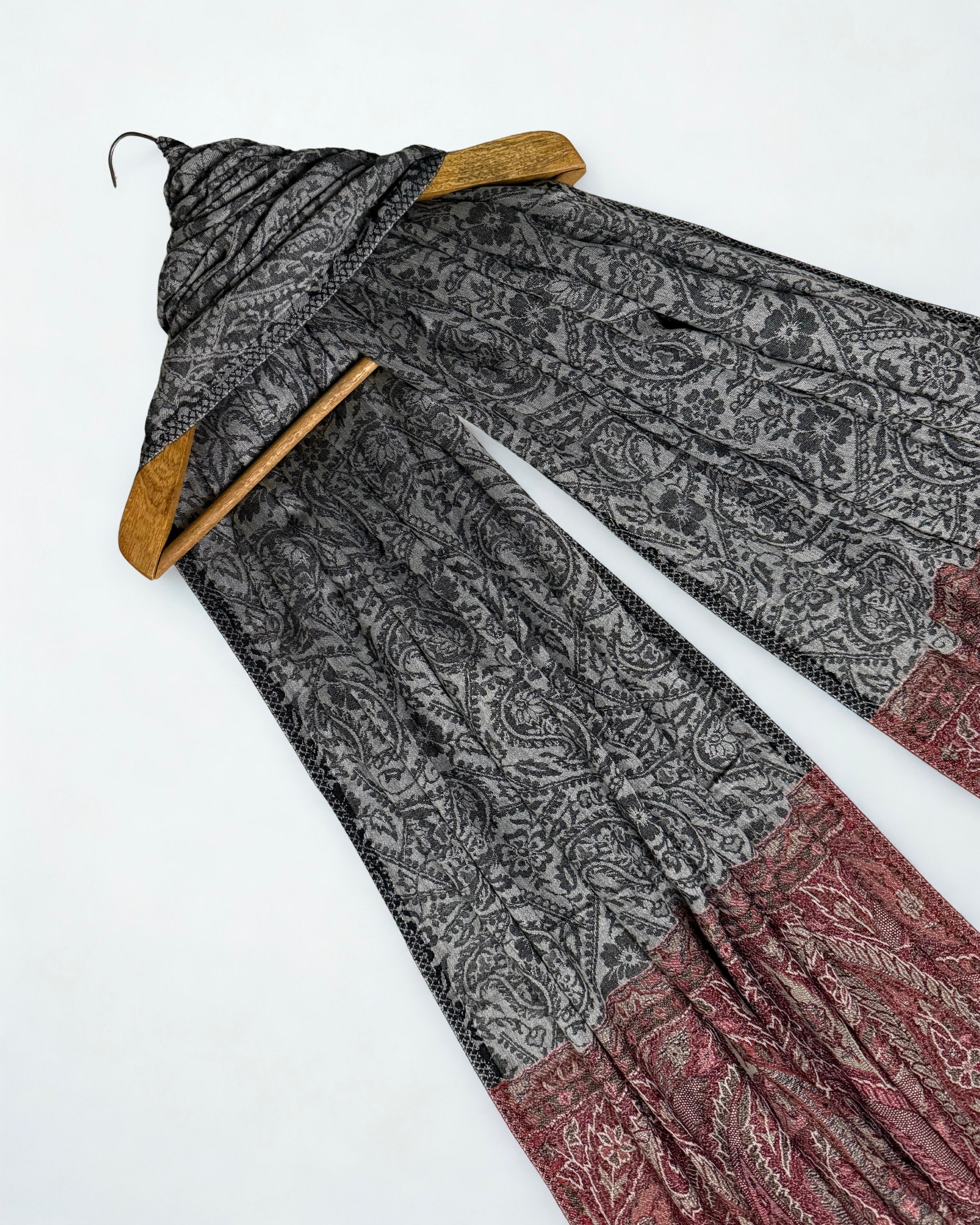 Both ends of the charcoal shawl side by side, borders matched