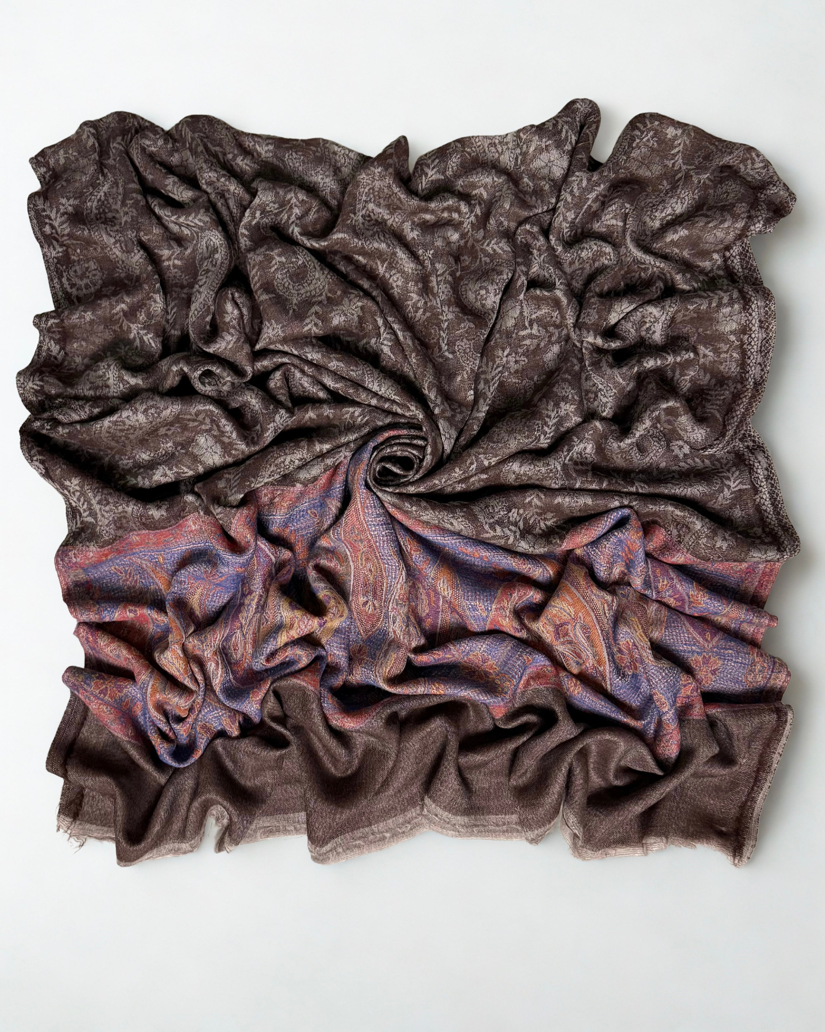 Full shawl laid flat, the paisley field reading as plain cocoa from a distance
