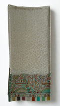 Stone grey pashmina shawl swirled to show its drape above the landscape border