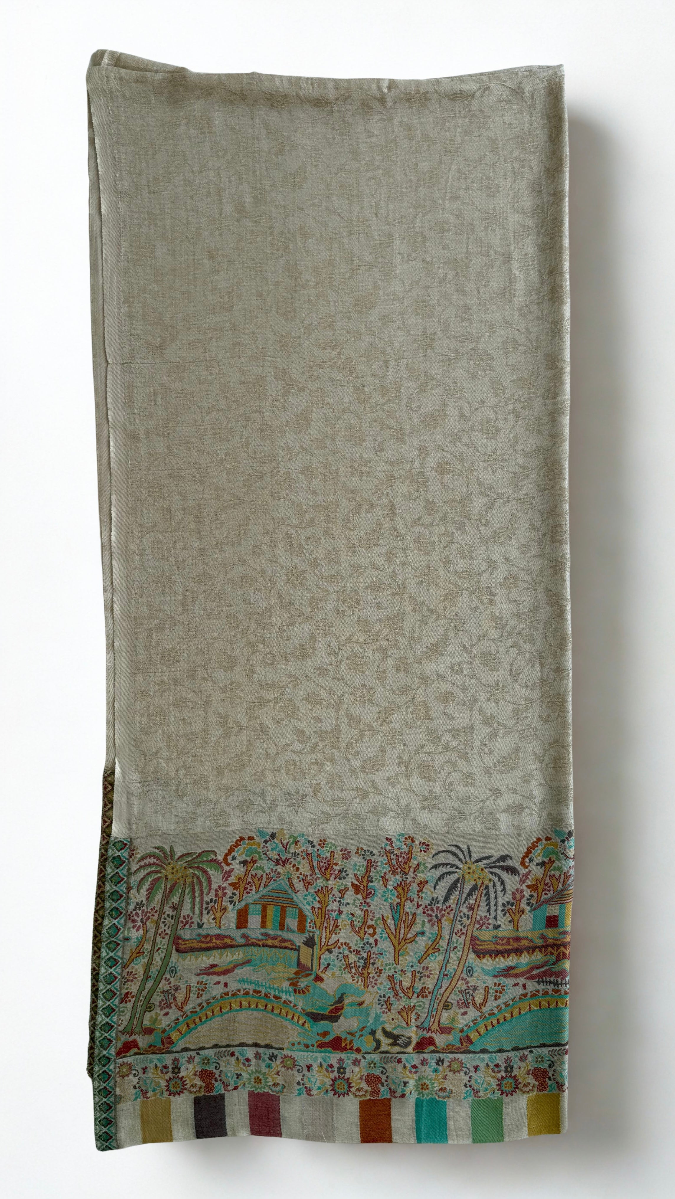 Stone grey pashmina shawl swirled to show its drape above the landscape border