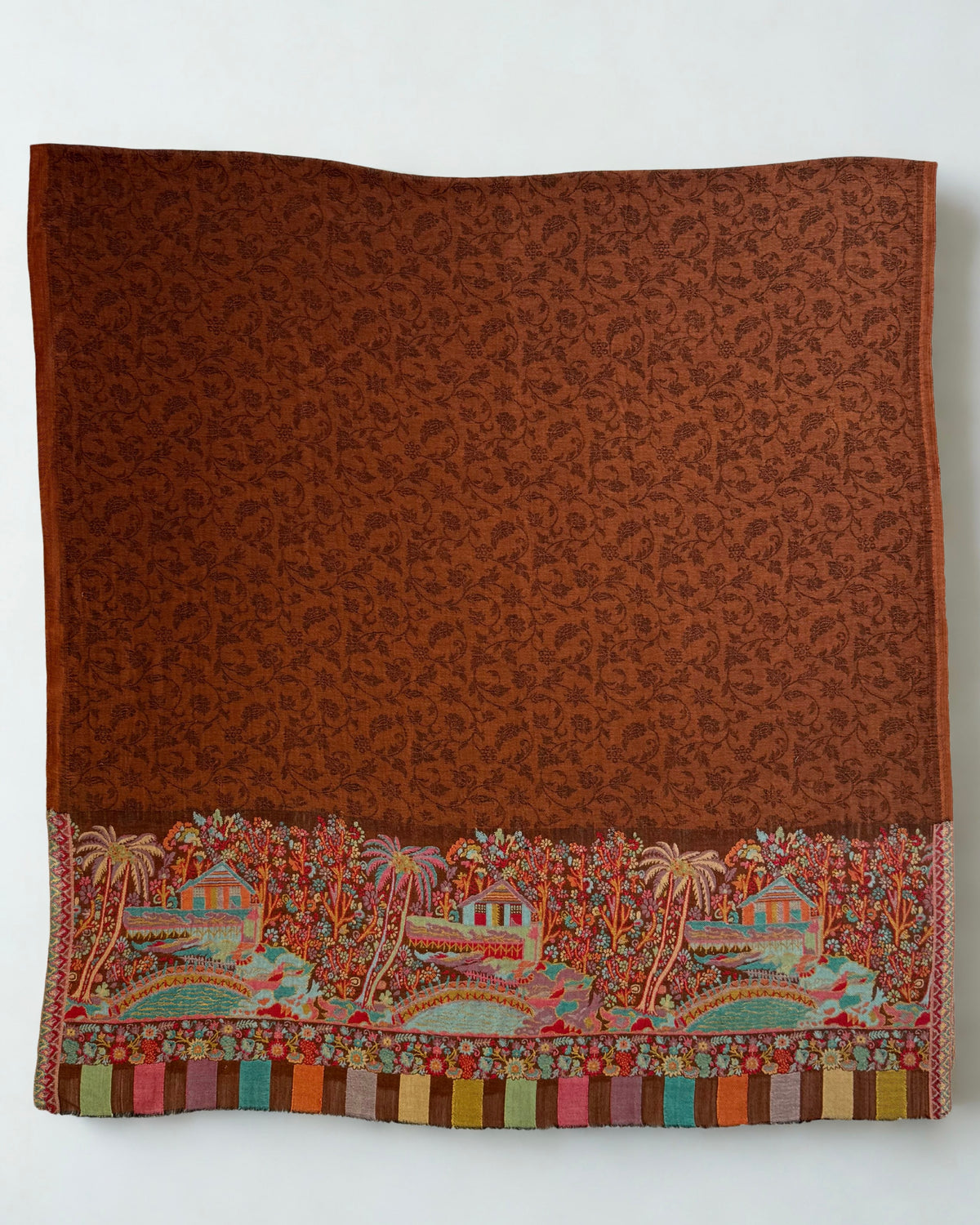Both ends of the rust shawl side by side, landscape panels and coloured blocks matched