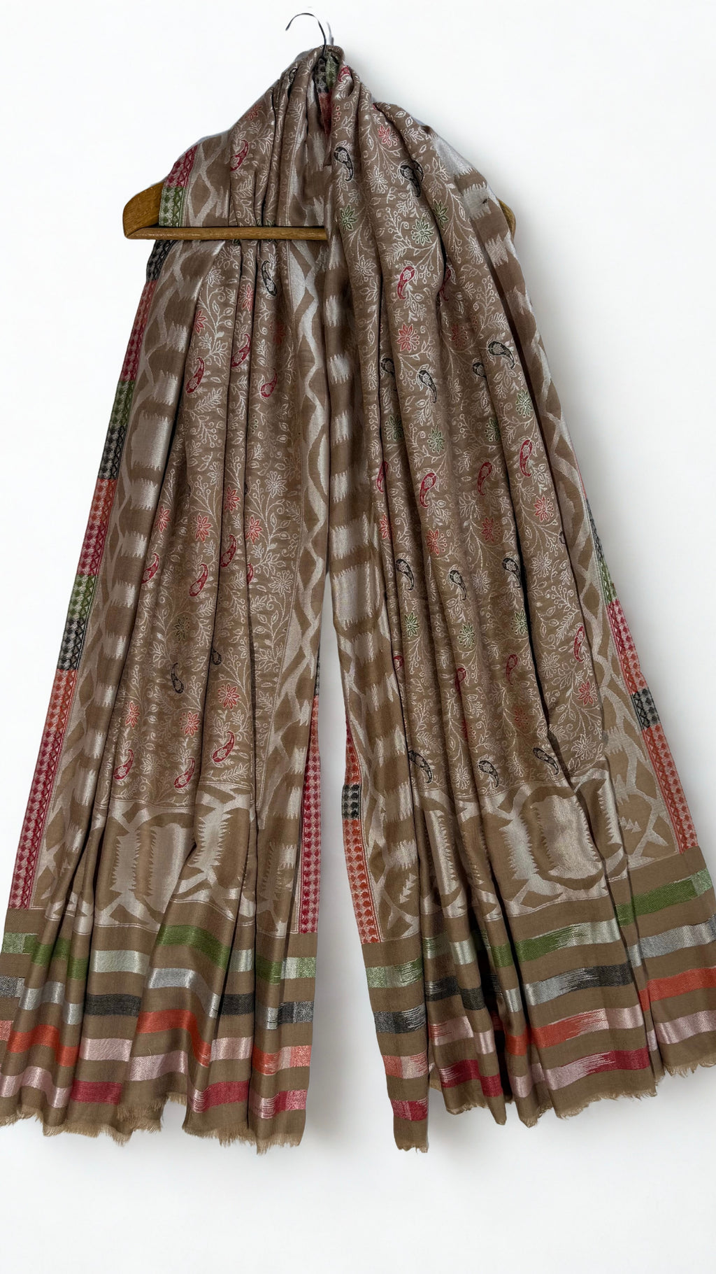 Detail of the small red, black and green paisley butis scattered across the silver flowering vine