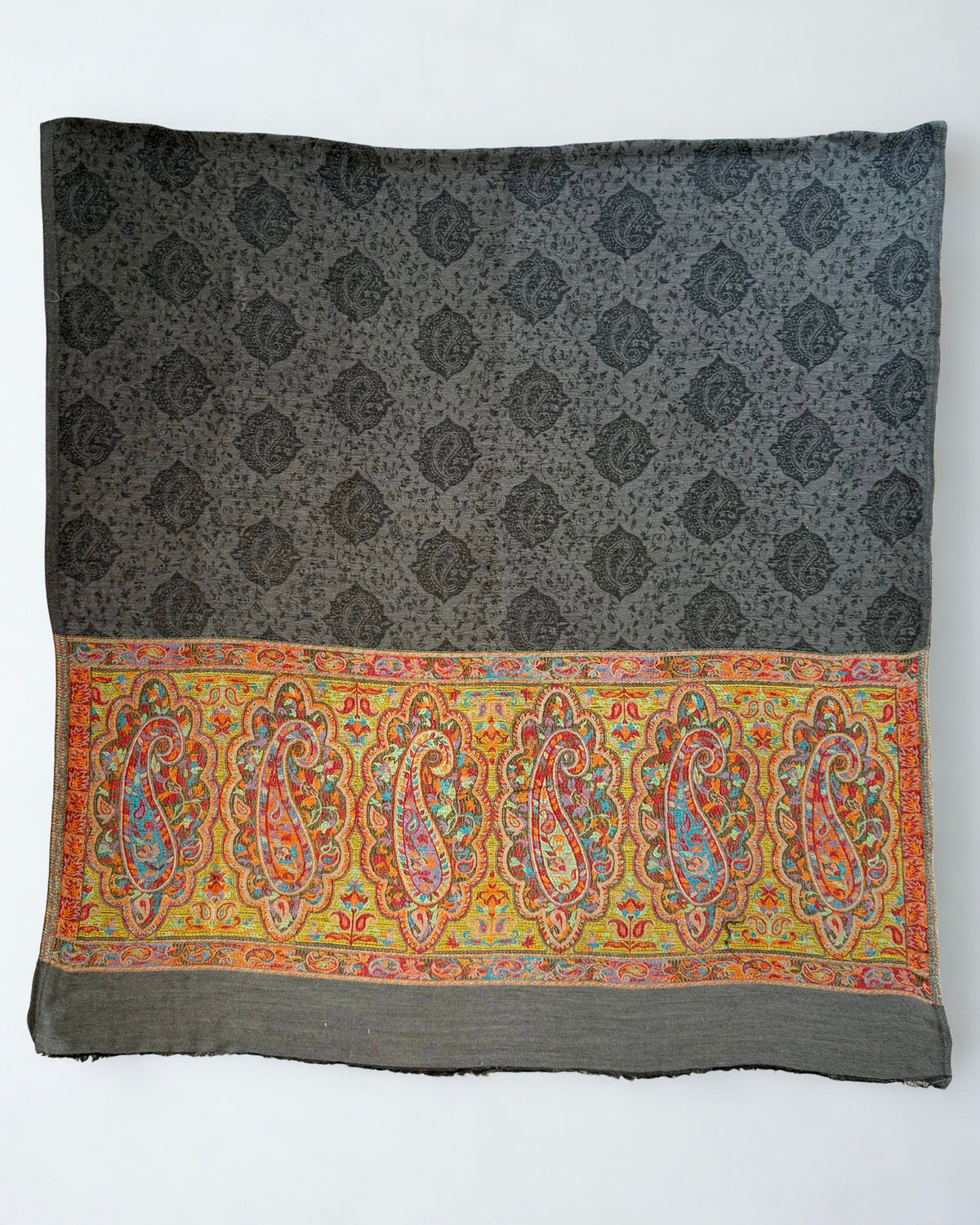 Graphite Palladar shawl on a wooden hanger showing the turquoise and lilac palla