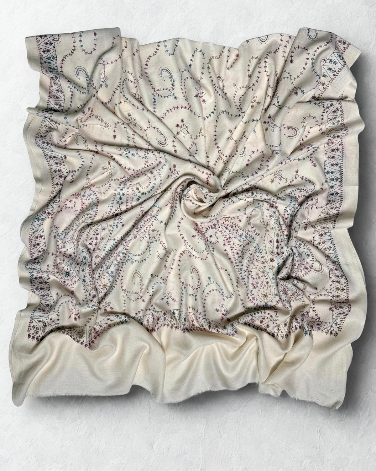 Hand-embroidered border and large corner paisleys on the white Swati Shahtoosh shawl