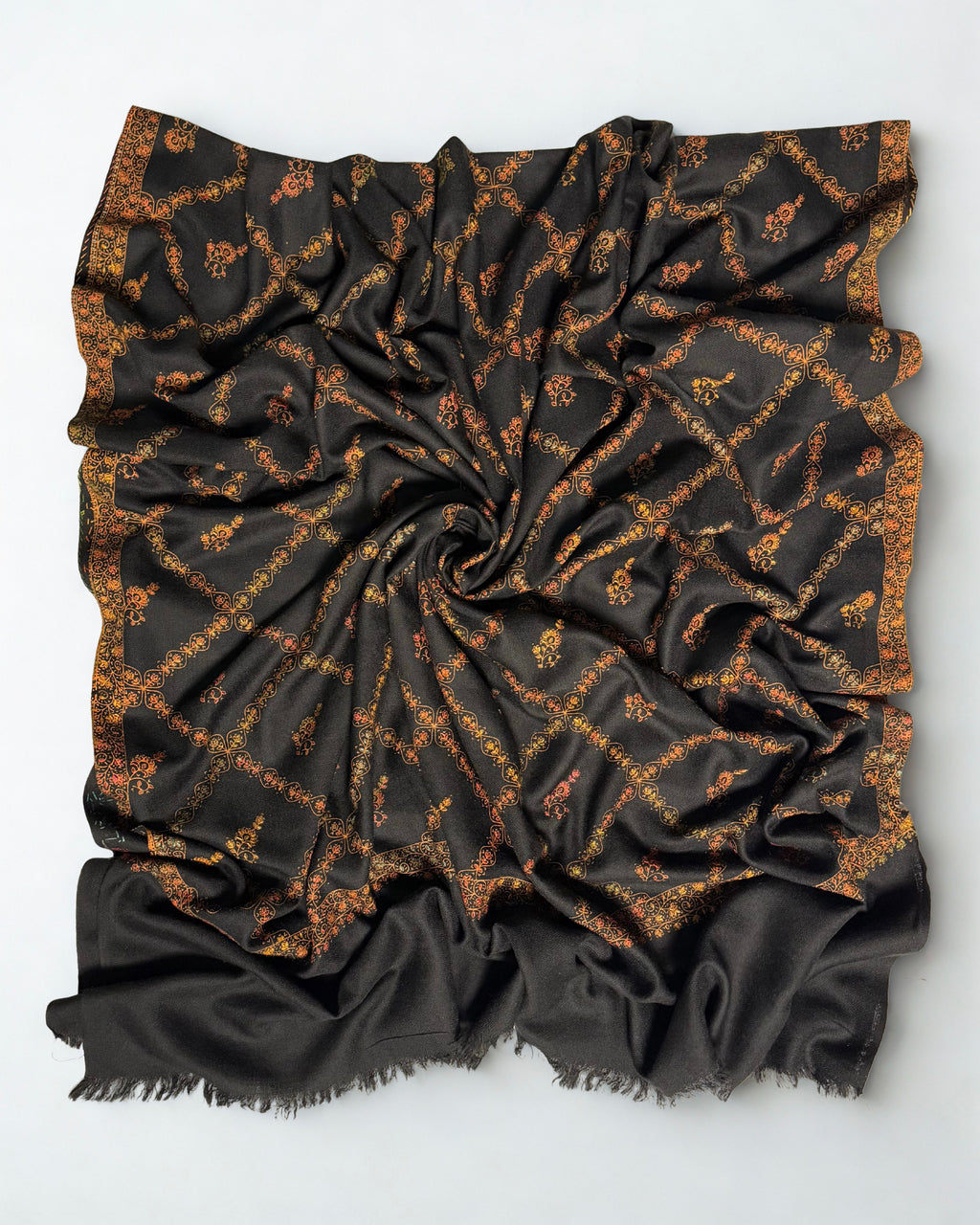 Black Swati Shahtoosh shawl swirled open, gold jaal embroidery covering the entire field