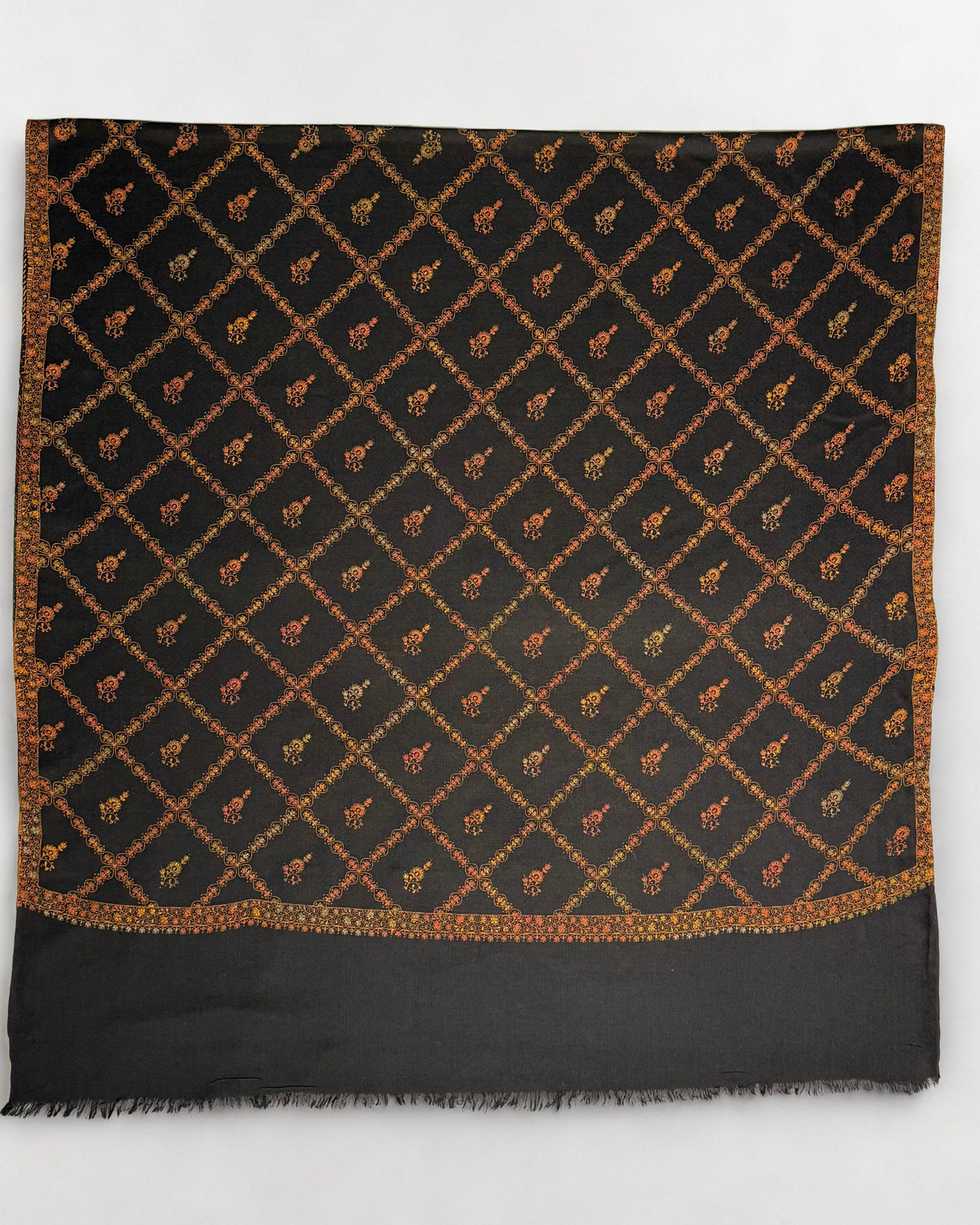 Black Swati Shahtoosh shawl opened flat, gold diamond lattice with a flowering buti in each diamond