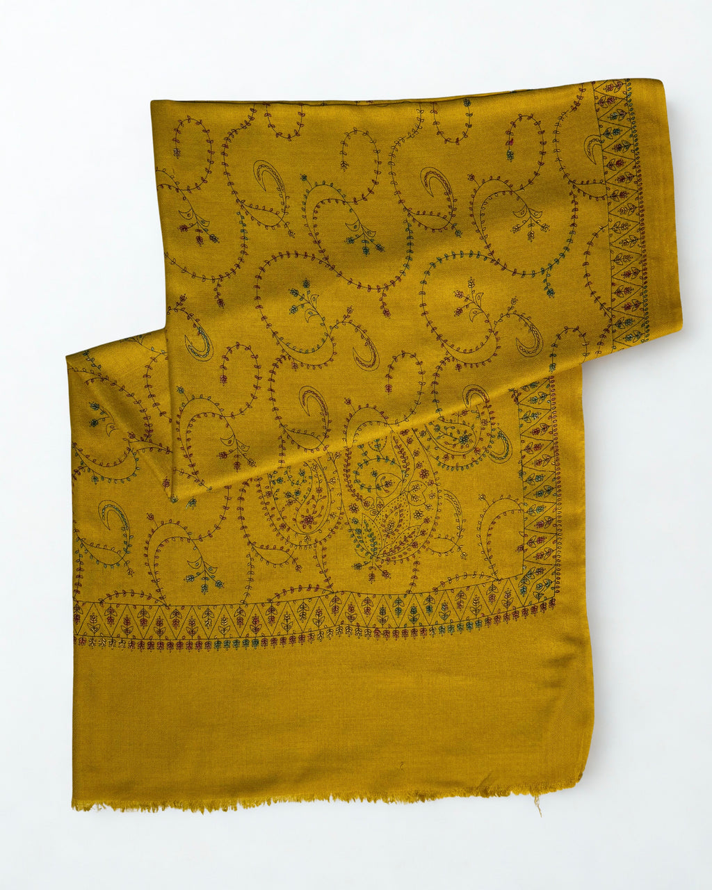 Mustard Swati Shahtoosh shawl folded with one end turned back, showing the embroidered border