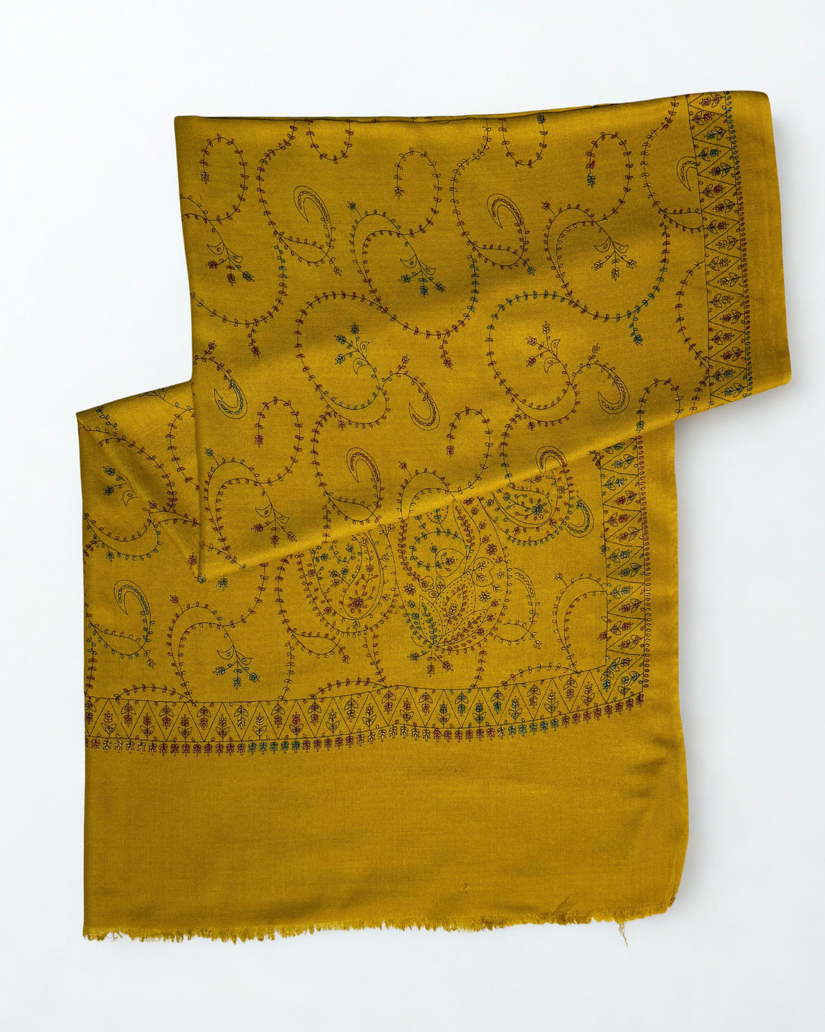 Mustard Swati Shahtoosh shawl folded with one end turned back, showing the embroidered border