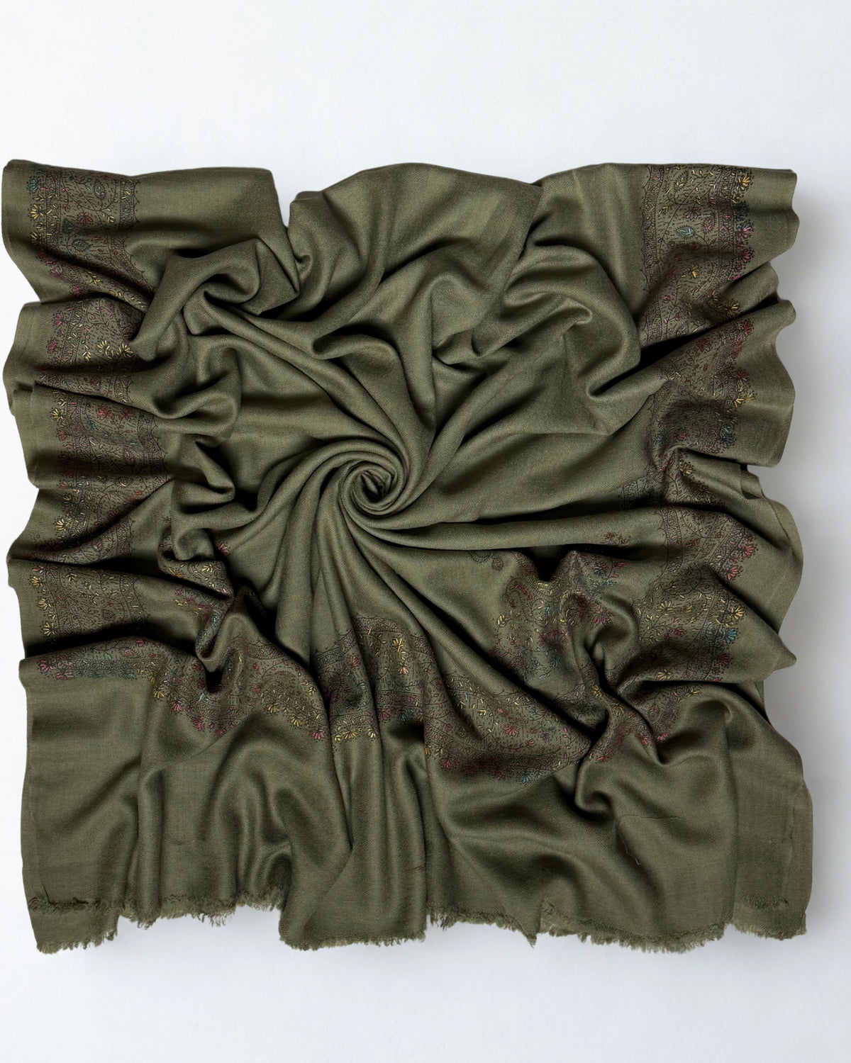 Olive green Swati Shahtoosh shawl swirled open, plain field with an embroidered border on all four sides