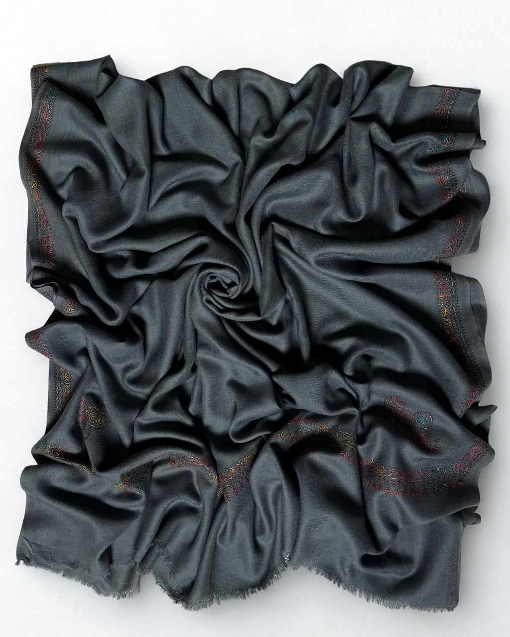Slate grey Swati Shahtoosh shawl swirled open, plain field with an embroidered border on all four sides