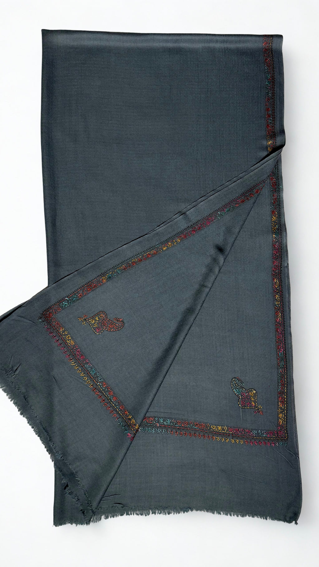 Slate grey Swati Shahtoosh shawl folded back to show two corner paisleys and the floral border