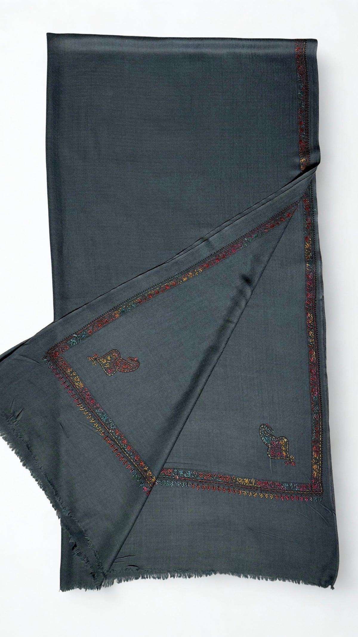 Slate grey Swati Shahtoosh shawl folded back to show two corner paisleys and the floral border