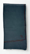 Slate grey Swati Shahtoosh shawl folded flat, corner paisley and fine hand-embroidered border