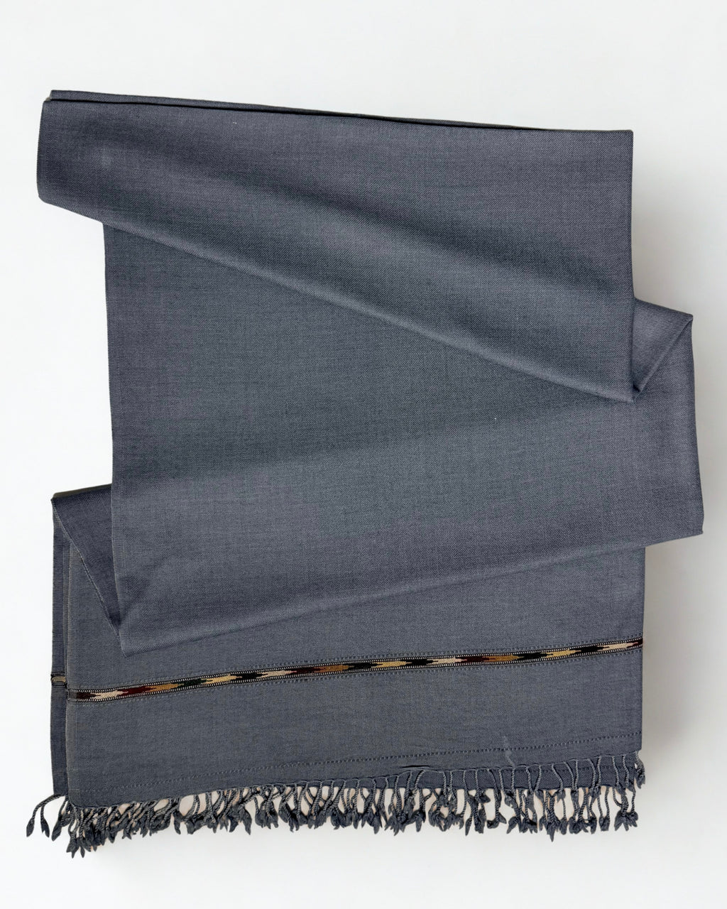 Grey men's Swati pashmina shawl folded, showing the red and gold woven band above the fringe