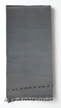 Grey men's Swati pashmina shawl folded flat, approx. 45 by 90 inches with a fringed end