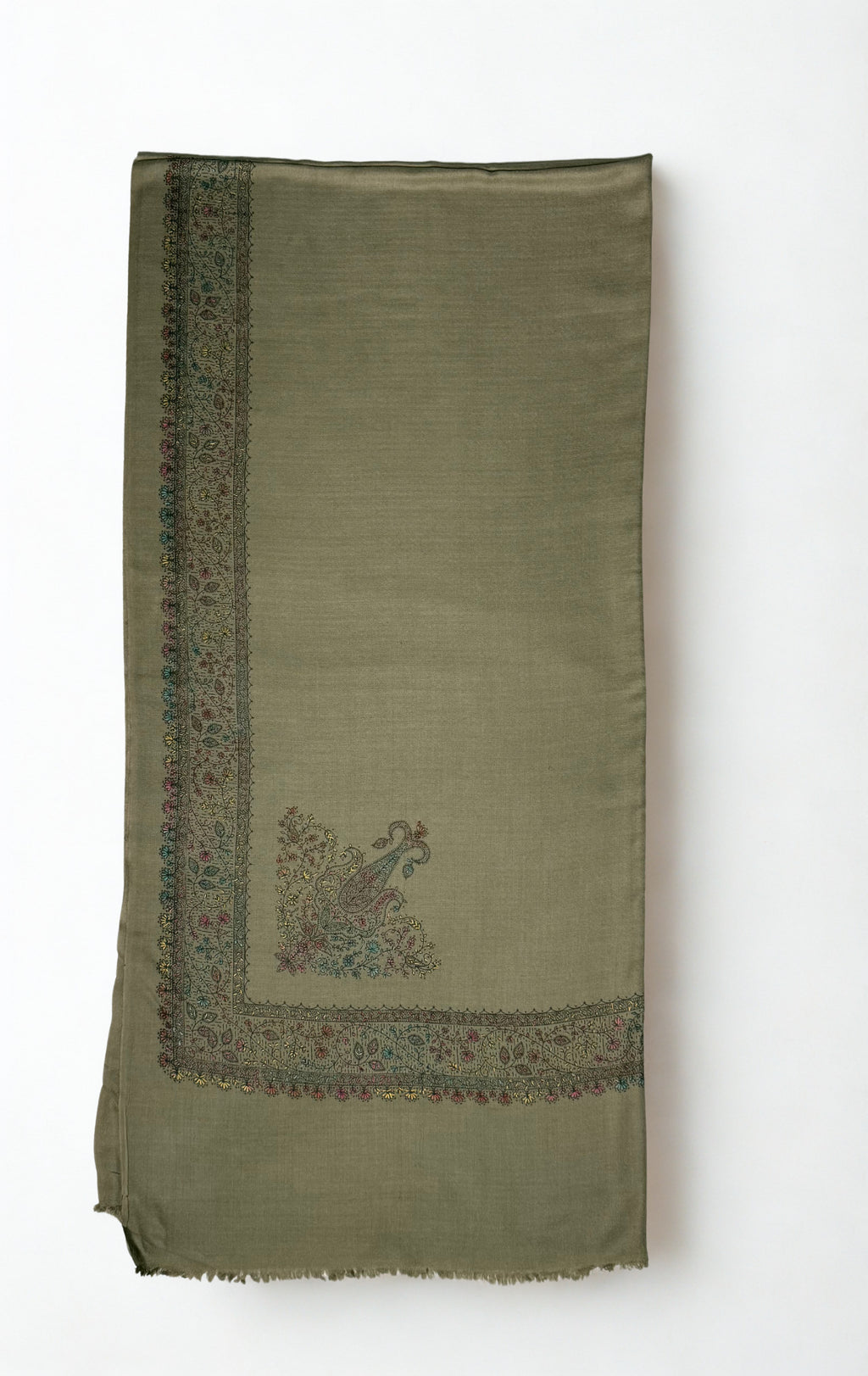 Grey Swati Shahtoosh shawl with one corner turned back, showing the embroidered vine border mitred at the corner around two flowering paisley motifs