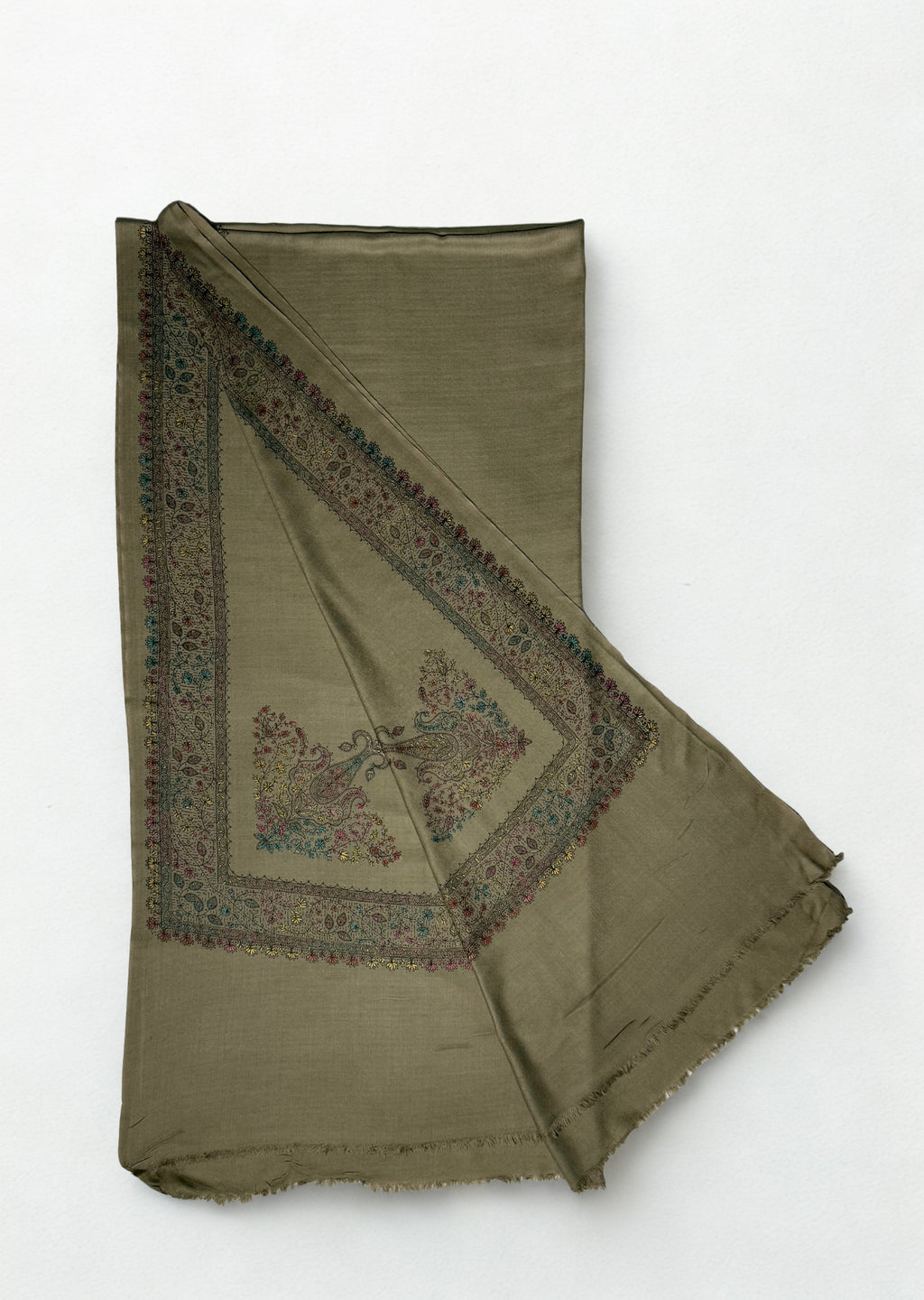 Grey Swati Shahtoosh shawl folded flat, the hand-embroidered floral vine border running down one edge with a large flowering paisley on the field