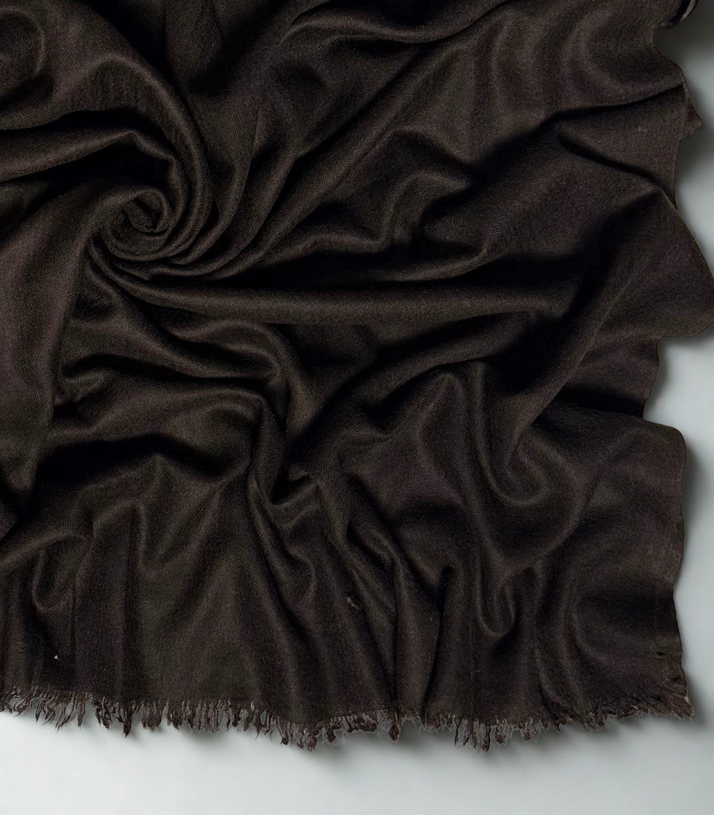 Close view of the espresso brown Swati Shahtoosh shawl in folds, showing the diamond weave texture and fringed edge