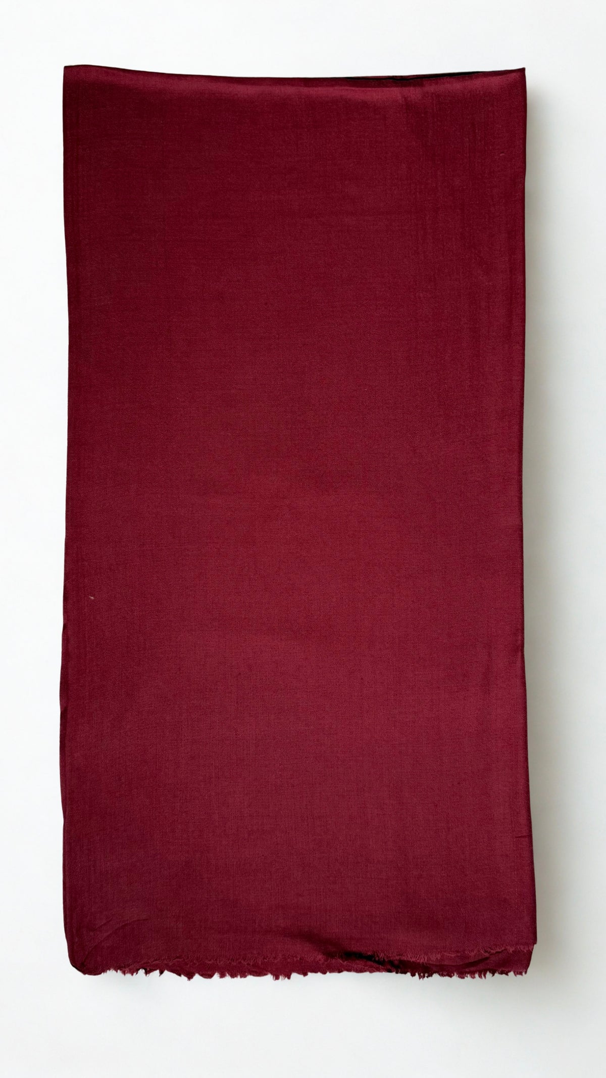 Maroon Swati Shahtoosh shawl folded lengthwise, showing the plain field, self-coloured diamond weave and fringed end
